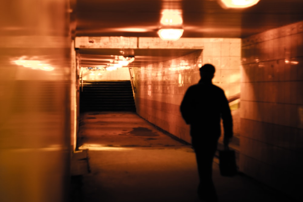 계단이 있는 건물 내부를 걷는 남자