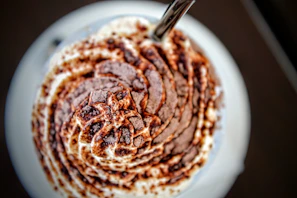 Close-up of a creamy chocolate whey protein shake with a splash effect.