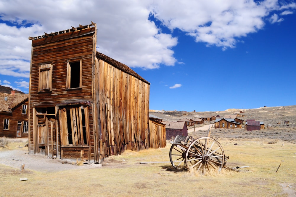 brown wooden house under white clouds