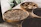 Close-up of a rustic basket overflowing with fresh Indian agro-products on a wooden table.
