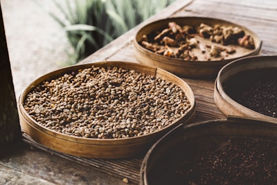 Close-up of high-quality legumes and spices arranged in rustic baskets.