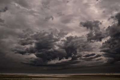 A dramatic sky over a windswept landscape, capturing the raw power of an approaching storm.