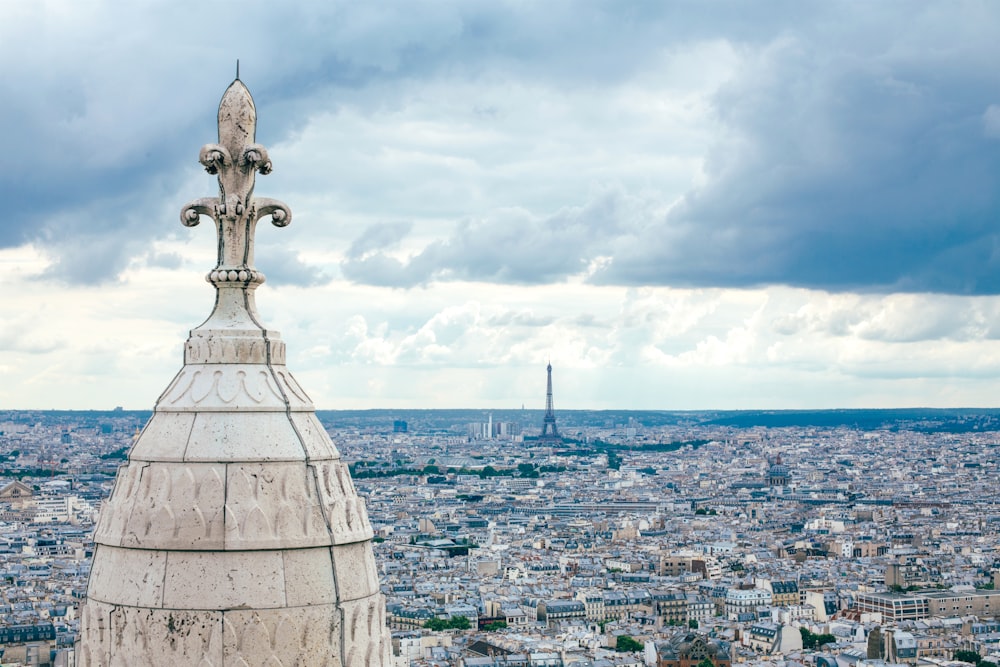 architectural photography of white concrete structure under cloudy sky