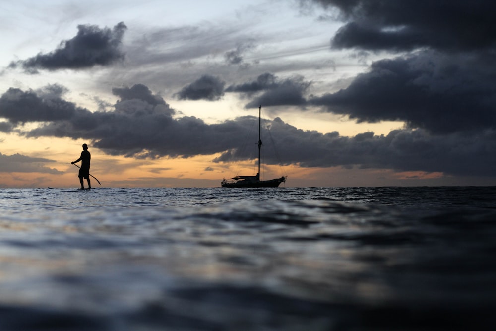 silhouette photo of boat during daytime