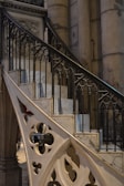 Close-up of custom steel railings with intricate patterns, set against rugged stone steps.