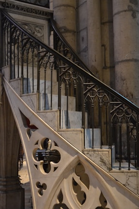 Close-up of custom steel railings with intricate patterns, set against rugged stone steps.