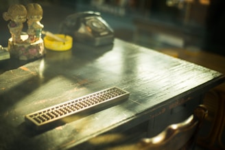 A nostalgic scene of two kids battling Spinjas tops on a wooden table, sunlight casting warm shadows.