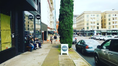 Street view of a busy commercial area with shops and cafes.