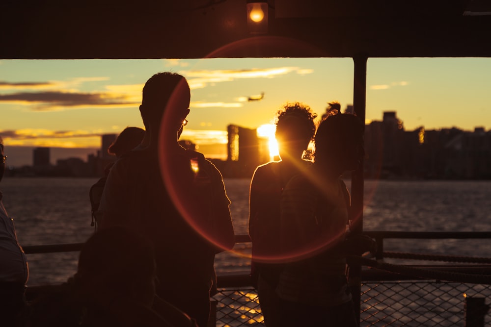 a group of people standing next to each other near a body of water