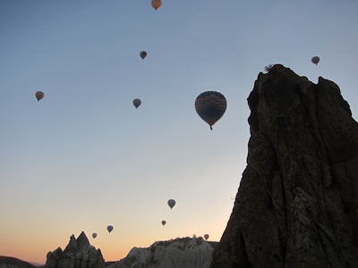 Hot air balloons floating over the Nile River at dawn.