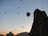 Sophisticated man in luxury attire enjoying a serene balloon flight over the Nile at dawn.