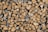 A stack of neatly arranged chopped firewood, featuring pieces of varying sizes and shapes, with visible textures and tree rings.