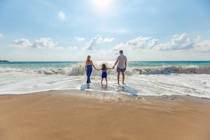Happy successful man and family at the beach