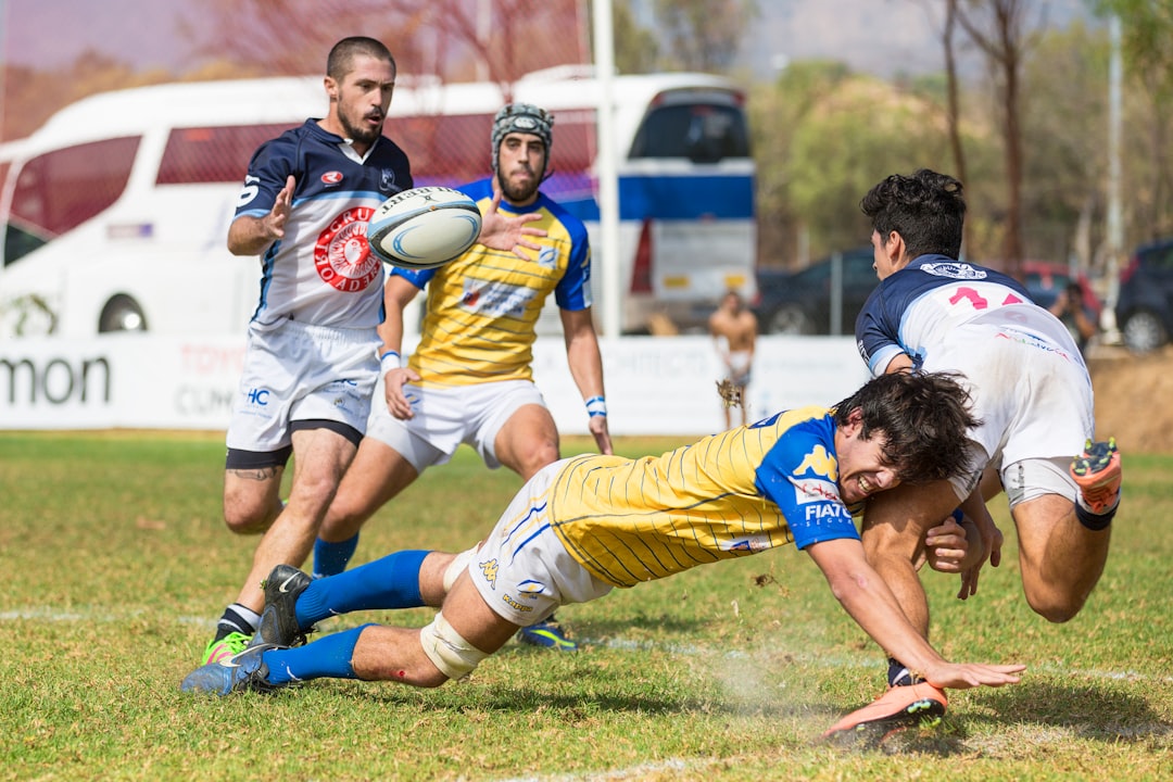 four men playing soccer