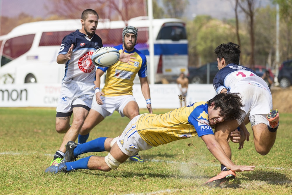 four men playing soccer