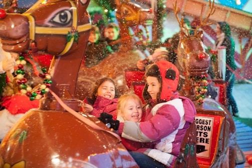 Families enjoying holiday activities in a winter-themed setting.