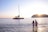 A joyful couple enjoying a sunset catamaran cruise in the Greek islands.
