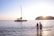 A joyful couple enjoying a sunset catamaran cruise in the Greek islands.