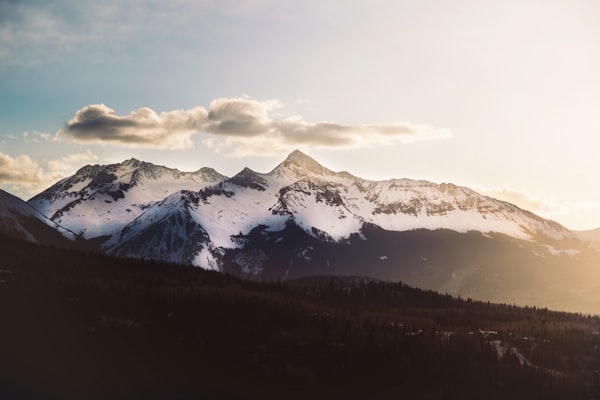 Snowbound San Juan peak under dramatic clouds near Telluride