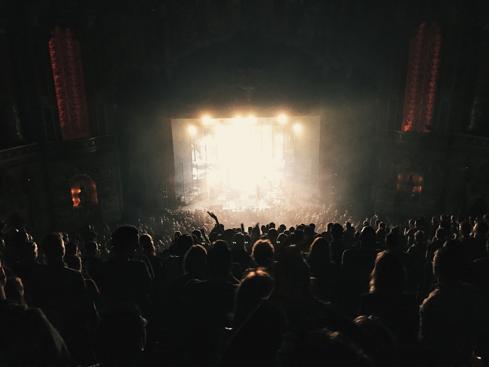 a crowd of people standing around a stage