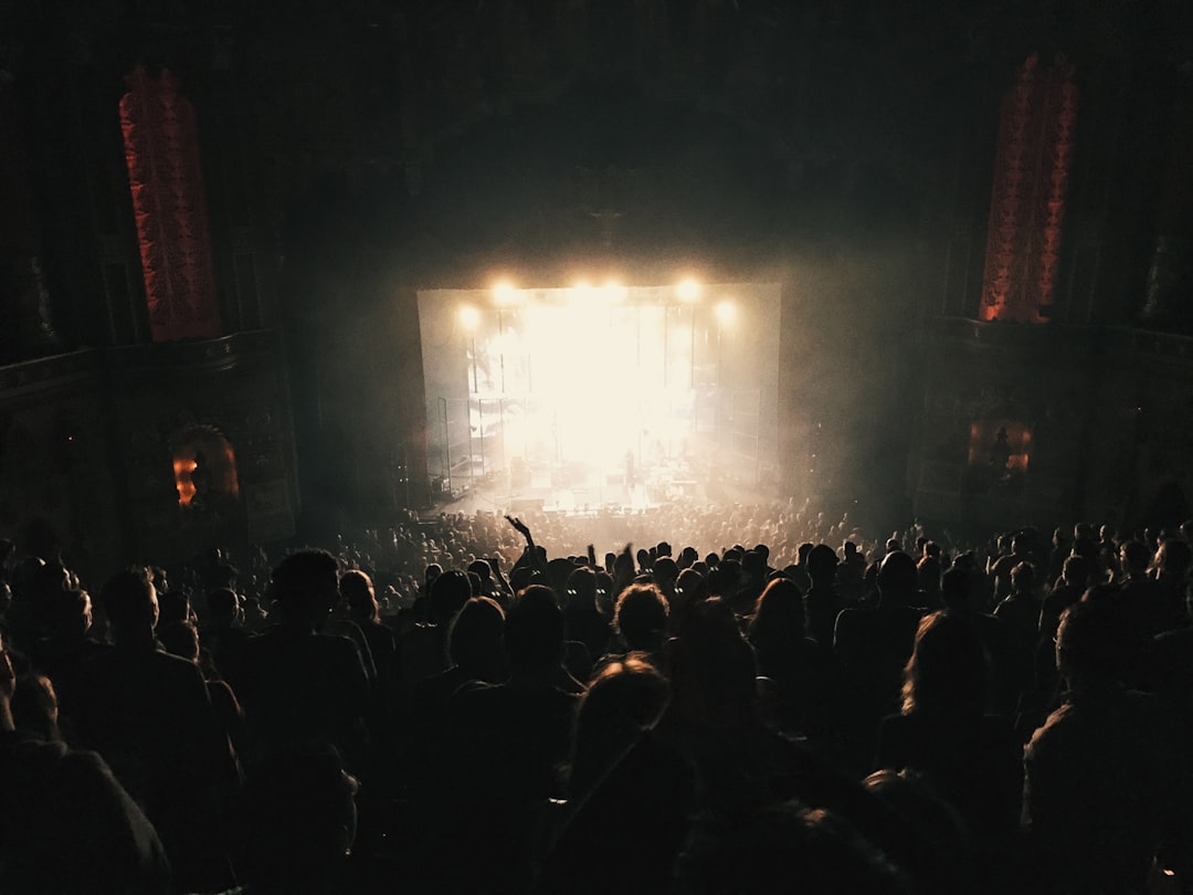 a crowd of people standing around a stage,
