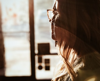 shallow focus photography of woman facing door