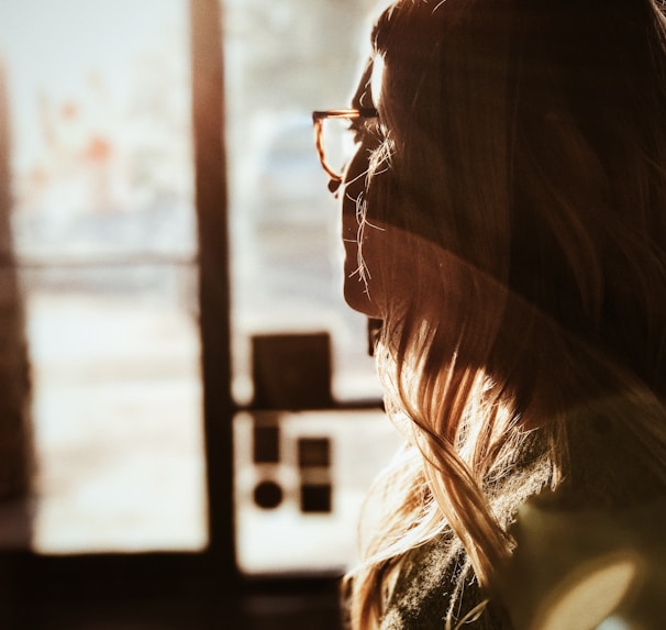 shallow focus photography of woman facing door