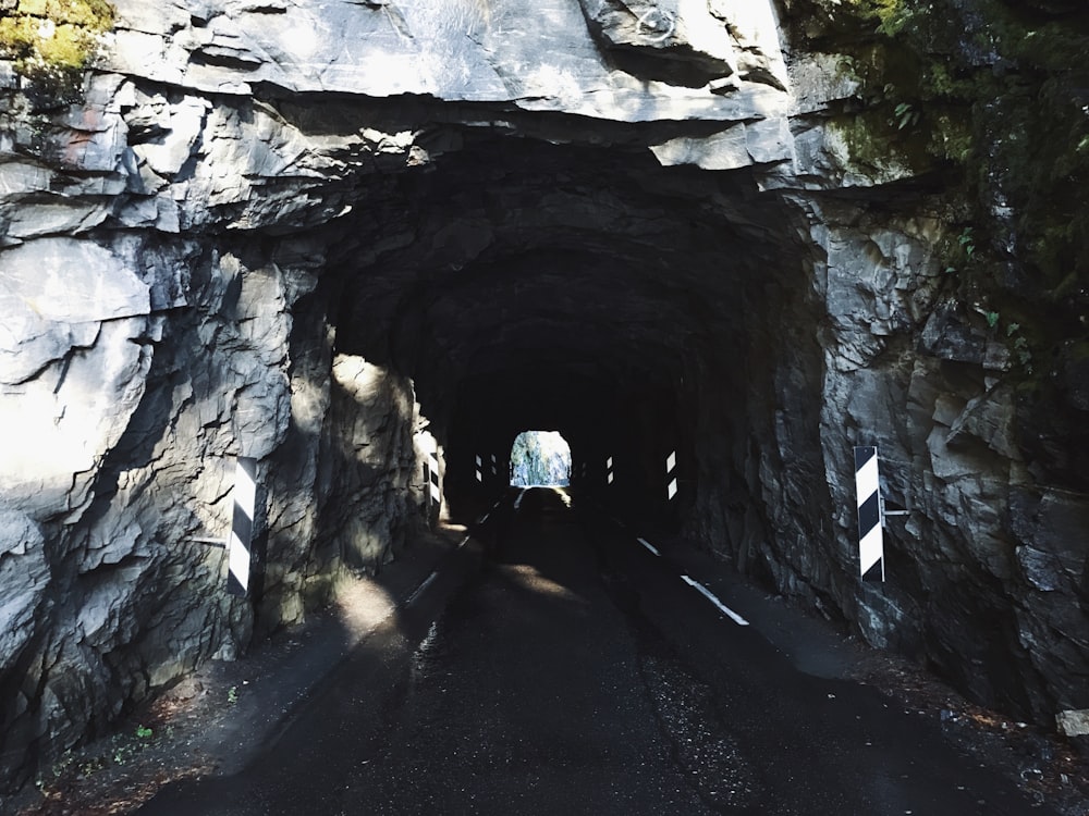 a car driving through a tunnel on a road