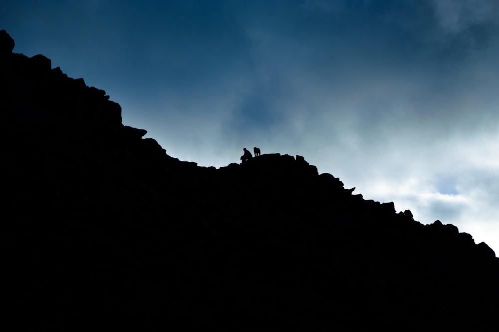 low angle of person on rock cliff