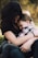 woman hugging boy on her lap