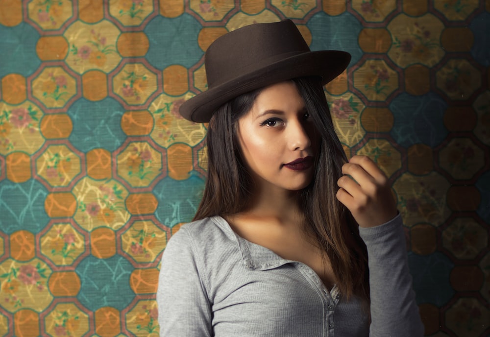 woman in gray long sleeve shirt wearing black fedora hat