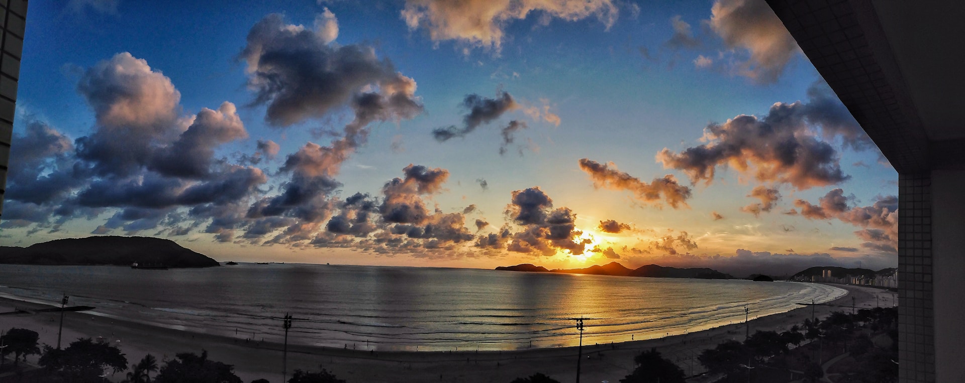 A picturesque sunset view from the balcony of Lavaggi Hotel, highlighting the serene beach atmosphere.