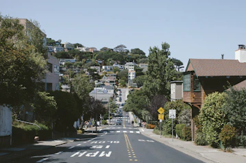 Instructor patiently guiding a teen driver through a quiet neighborhood street