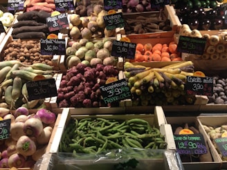 Colorful display of fresh vegetables from around the world arranged in wooden crates