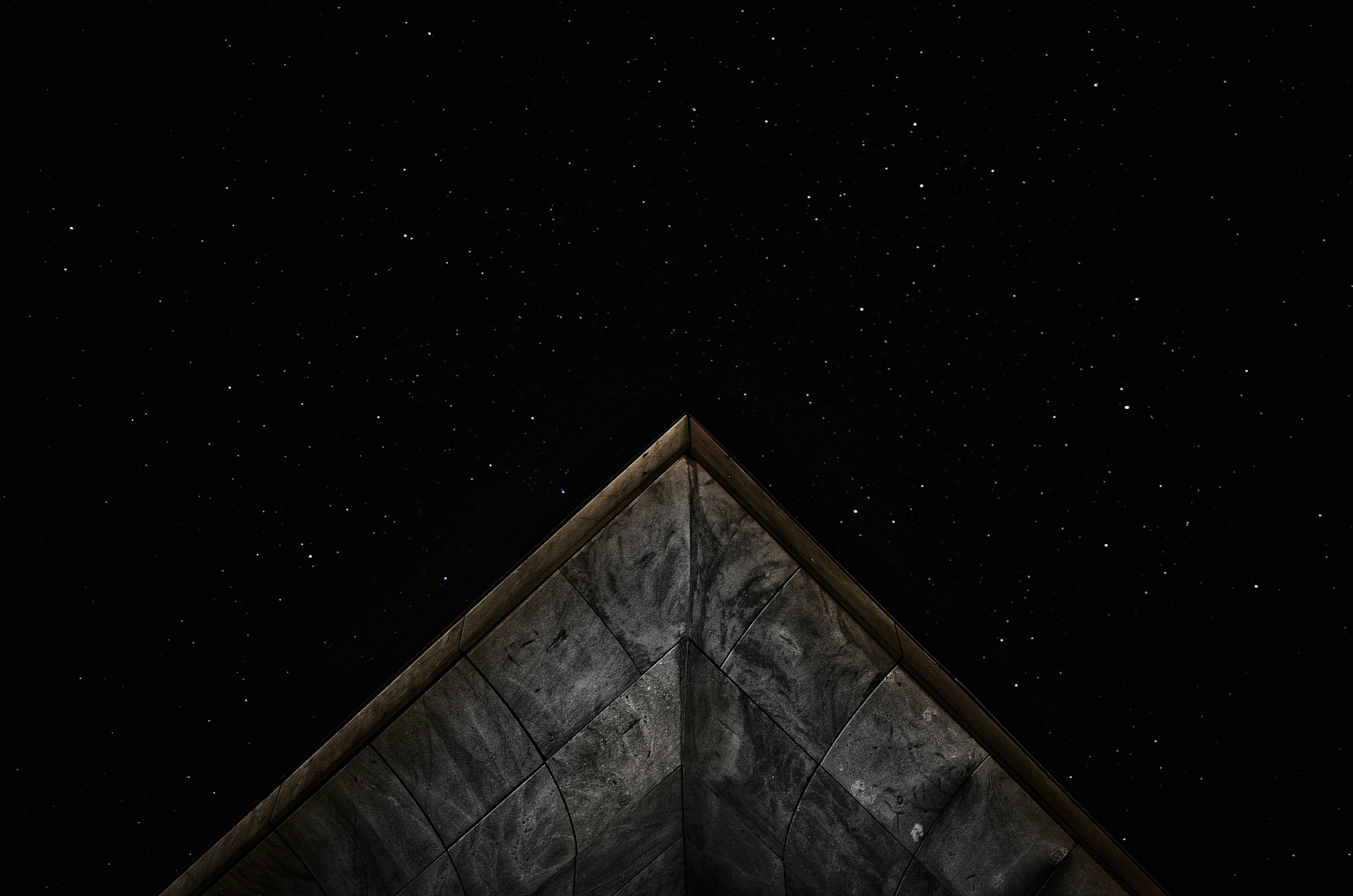 gray roof under starry sky at nighttime