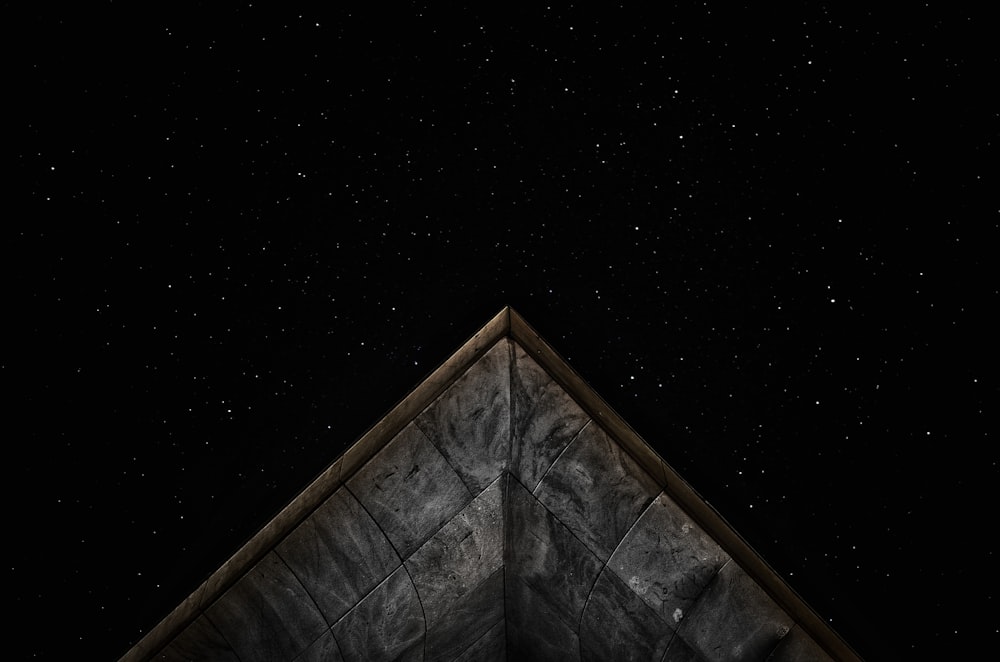 gray roof under starry sky at nighttime