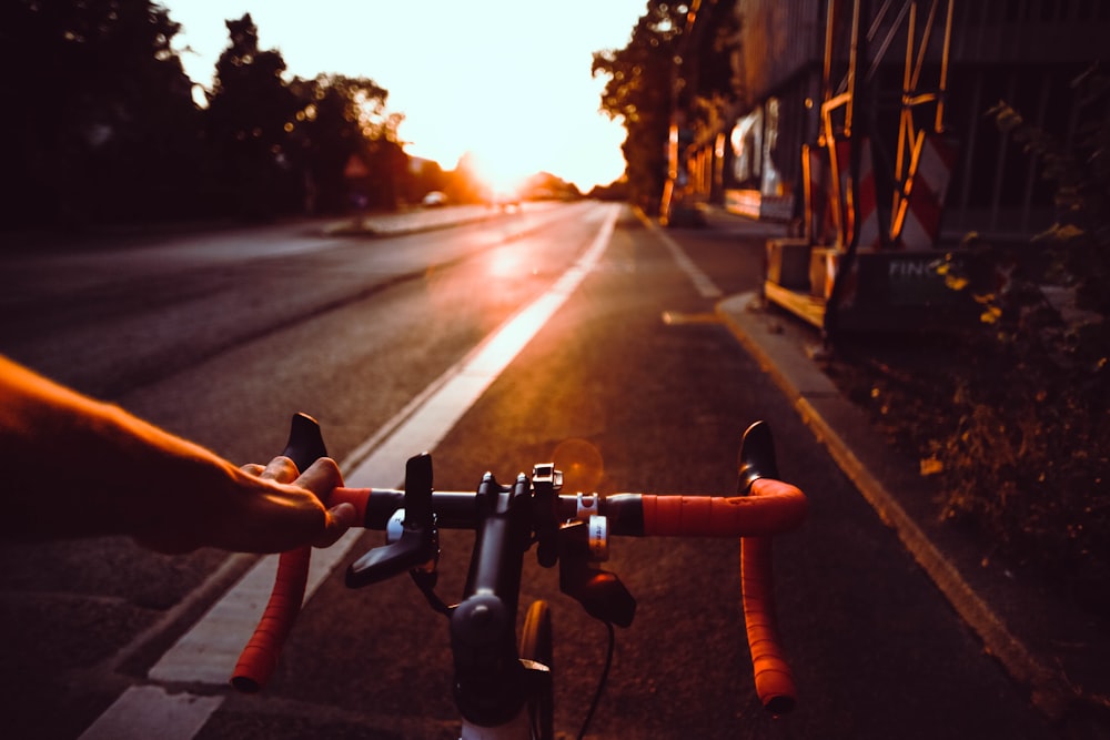 person riding on bicycle on road