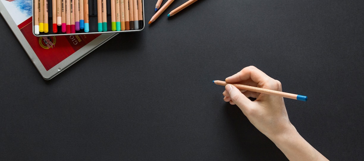 person holding brown pencil