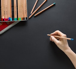 person holding brown pencil