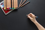 person holding brown pencil