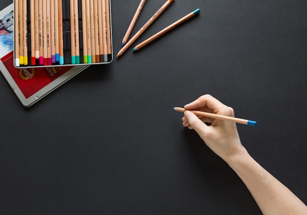 person holding brown pencil