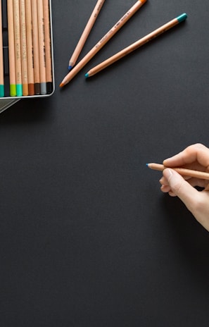 person holding brown pencil