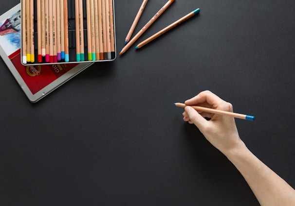 person holding brown pencil