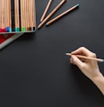 person holding brown pencil