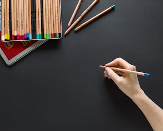 person holding brown pencil