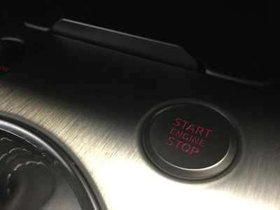 A customer happily clicking a button on a laptop labeled 'Determine my engine model'.