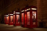 five red lined phone booths near building