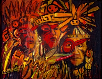 A vivid and energetic painting featuring abstract indigenous faces adorned with vibrant headgear and ornaments. The composition is filled with swirling patterns and symbols, predominantly in warm shades of red, orange, and yellow. The brushstrokes are dynamic, suggesting movement and intensity.