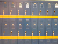 Rows of colorful lockers installed in a school hallway.
