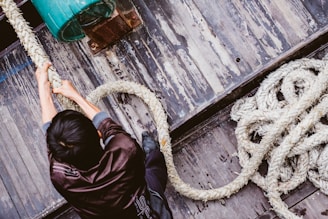 man pulling gray rope